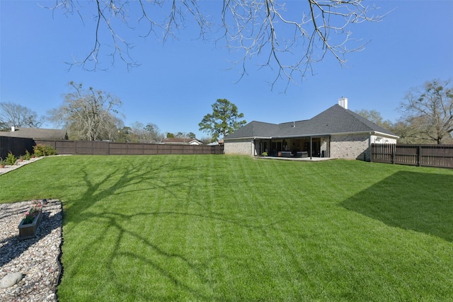 view of yard with a patio area and a fenced backyard