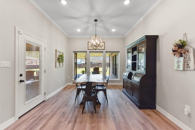 dining room featuring a chandelier, light wood-type flooring, and baseboards