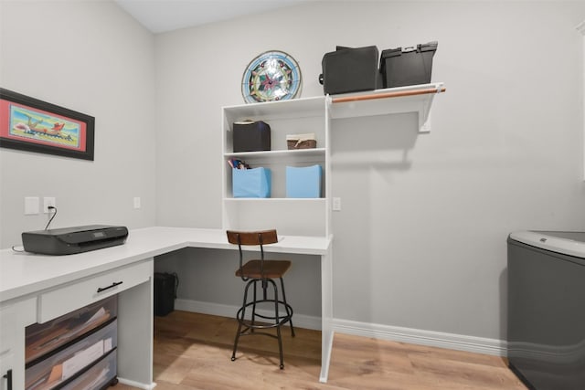 laundry area featuring baseboards and light wood-style floors