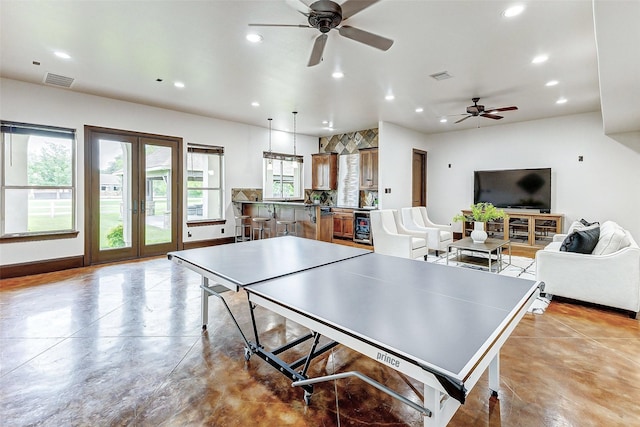 recreation room with finished concrete flooring, recessed lighting, visible vents, and ceiling fan