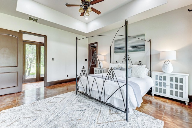 tiled bedroom featuring a raised ceiling, recessed lighting, baseboards, and visible vents