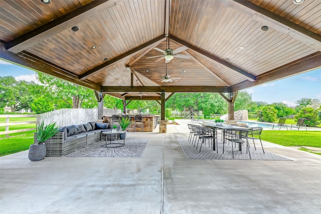 view of patio with an outdoor kitchen, outdoor dining area, ceiling fan, a gazebo, and outdoor lounge area