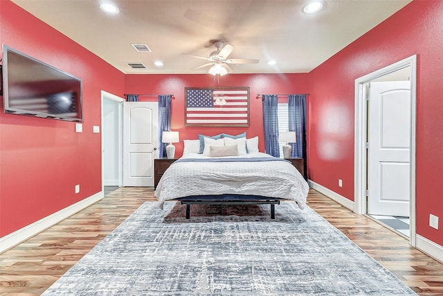 bedroom with light wood finished floors, visible vents, recessed lighting, and baseboards