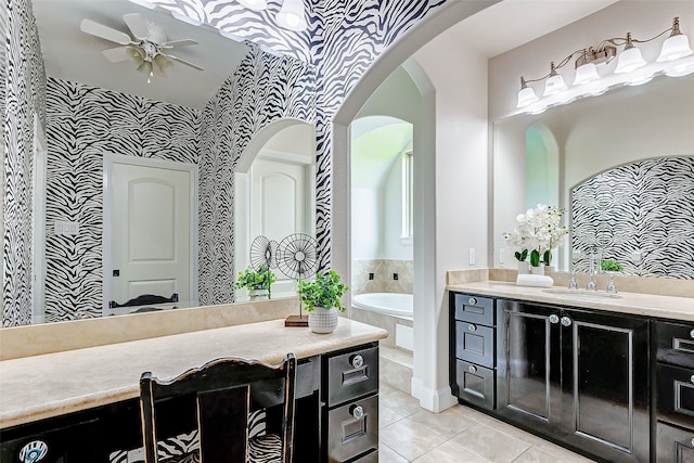 full bath featuring vanity, tile patterned floors, a garden tub, and a ceiling fan