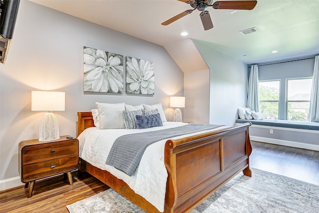 bedroom featuring ceiling fan, visible vents, baseboards, and wood finished floors