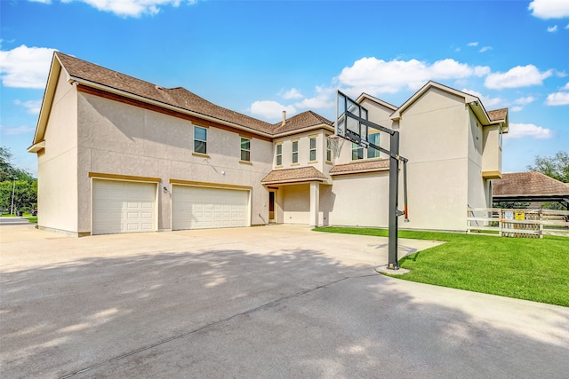 view of front of home featuring a front lawn, concrete driveway, a garage, and stucco siding