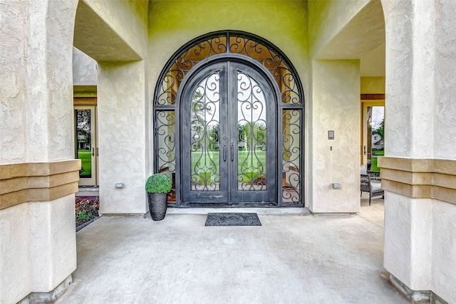 doorway to property with french doors and stucco siding