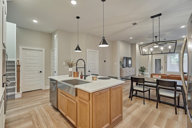 kitchen with recessed lighting, appliances with stainless steel finishes, light wood-type flooring, and a sink