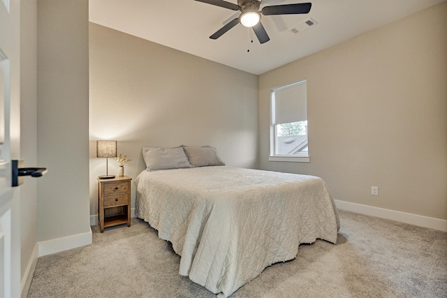 bedroom with visible vents, light carpet, baseboards, and ceiling fan