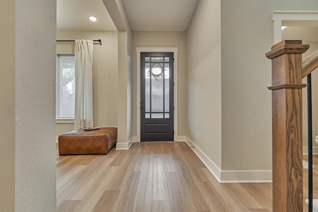 entrance foyer featuring baseboards and wood finished floors