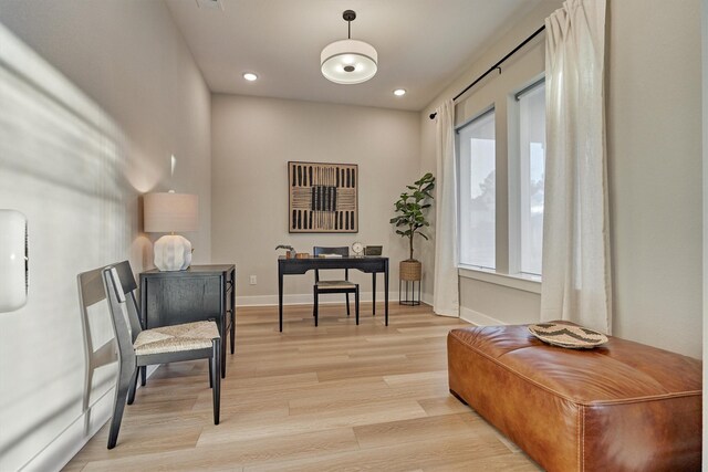 living area with recessed lighting, baseboards, and light wood-style floors