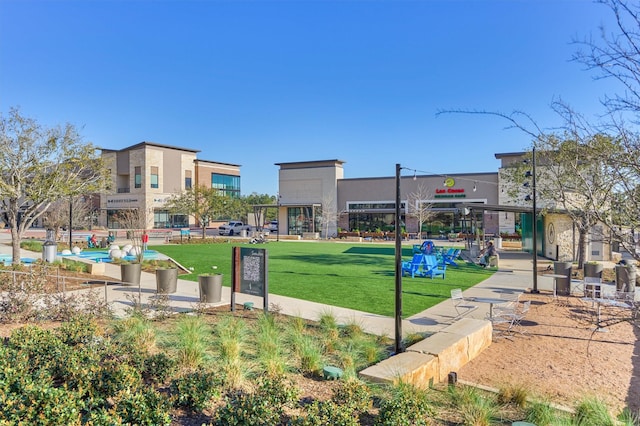 view of property's community with a lawn