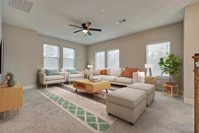 carpeted living room with baseboards, visible vents, and ceiling fan