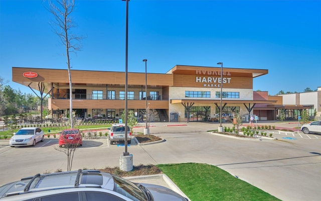 view of building exterior featuring uncovered parking