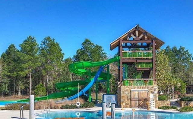 view of playground featuring a community pool