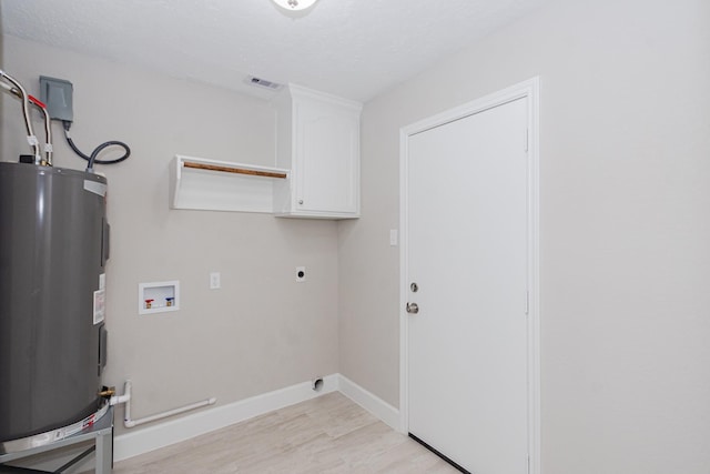 clothes washing area with electric dryer hookup, washer hookup, electric water heater, cabinet space, and light wood finished floors