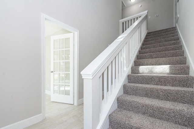 stairs featuring baseboards and wood finished floors