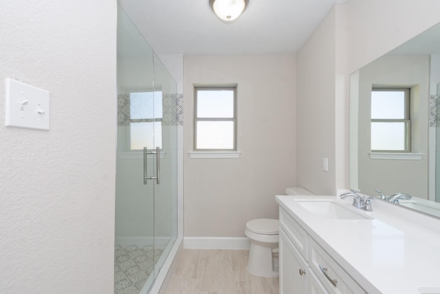 full bathroom with a wealth of natural light, a stall shower, toilet, and a sink