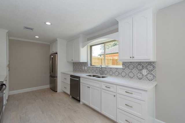 kitchen with white cabinetry, tasteful backsplash, visible vents, and stainless steel appliances