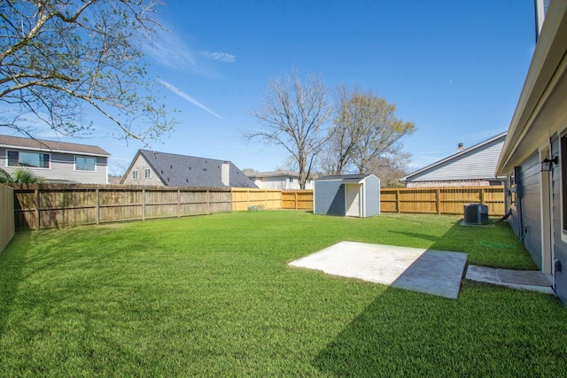 view of yard featuring a fenced backyard, central AC, an outdoor structure, and a shed