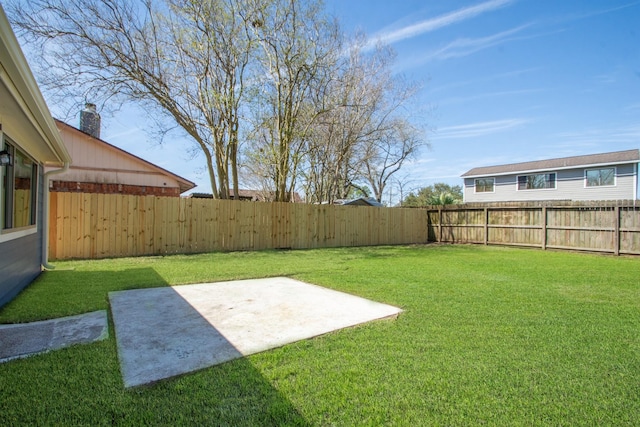 view of yard featuring a patio and a fenced backyard