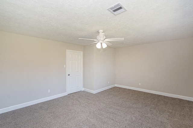 spare room with a ceiling fan, carpet flooring, baseboards, and visible vents