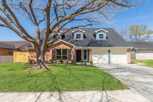 view of front facade with a front lawn, driveway, fence, a garage, and brick siding