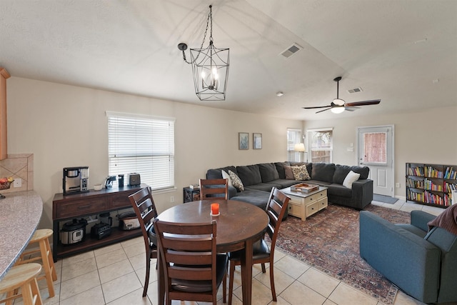 dining space with plenty of natural light, light tile patterned flooring, and visible vents