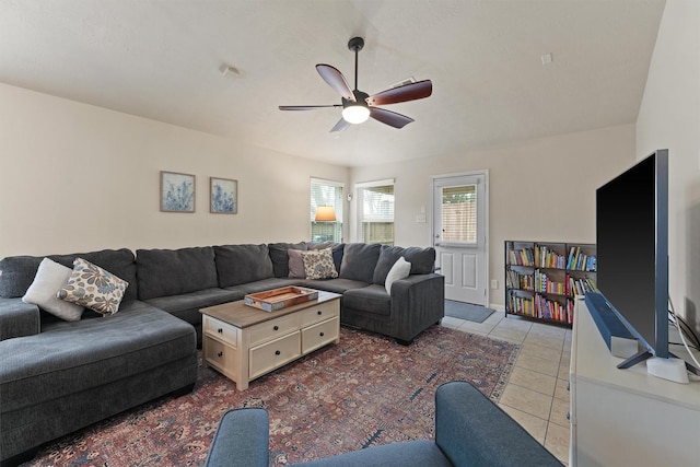 living area with light tile patterned flooring and a ceiling fan