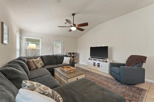 living area with light tile patterned floors, baseboards, lofted ceiling, and a ceiling fan