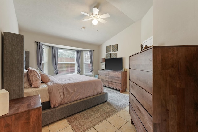 bedroom with lofted ceiling, light tile patterned flooring, and a ceiling fan