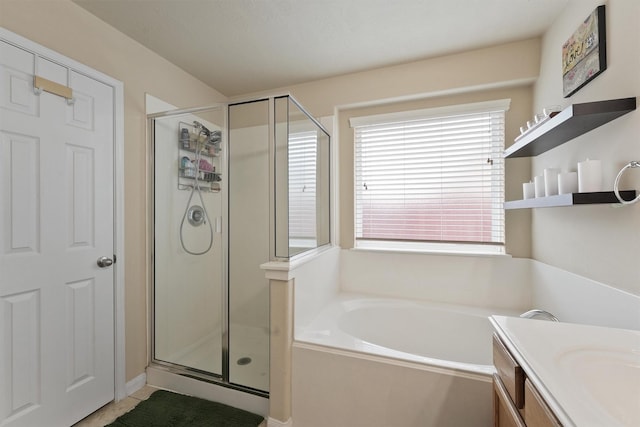 bathroom with vanity, a bath, and a shower stall