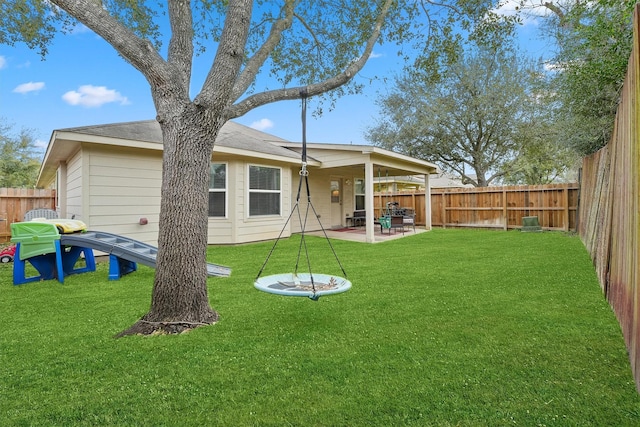 back of house with a patio, a lawn, and a fenced backyard