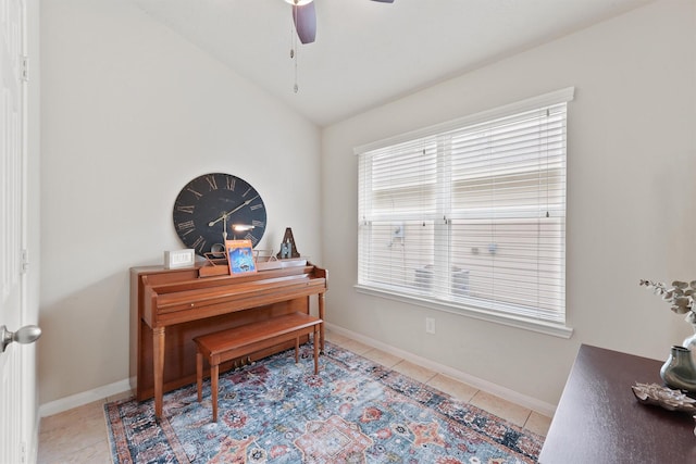 office space with light tile patterned floors, baseboards, lofted ceiling, and a ceiling fan