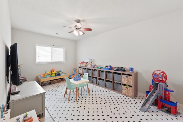 rec room with visible vents, baseboards, and ceiling fan