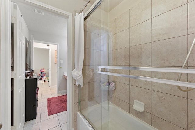 full bathroom featuring visible vents, baseboards, bath / shower combo with glass door, and tile patterned flooring