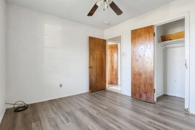 unfurnished bedroom with ceiling fan, baseboards, and wood finished floors