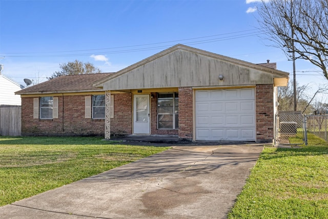 view of front of house with a front yard, fence, brick siding, and driveway