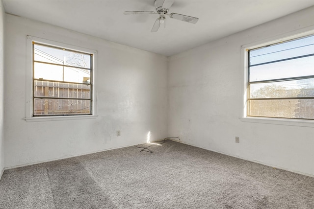 carpeted spare room with ceiling fan