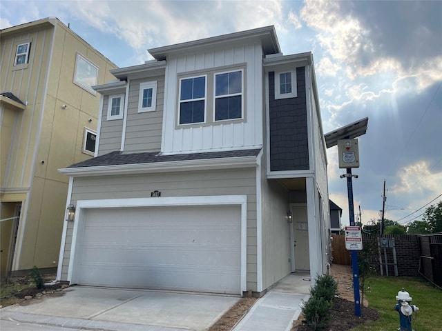 5617 Iris Harvest Dr, Houston, TX 77091 - townhome / multi-family property with board and batten siding, an attached garage, concrete driveway, and roof with shingles