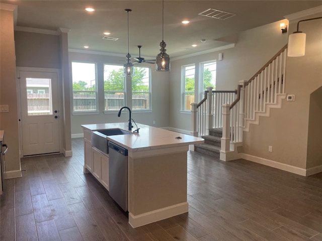 5617 Iris Harvest Dr, Houston, TX 77091 - kitchen with ornamental molding, stainless steel dishwasher, dark wood-type flooring, white cabinetry, and a center island with sink