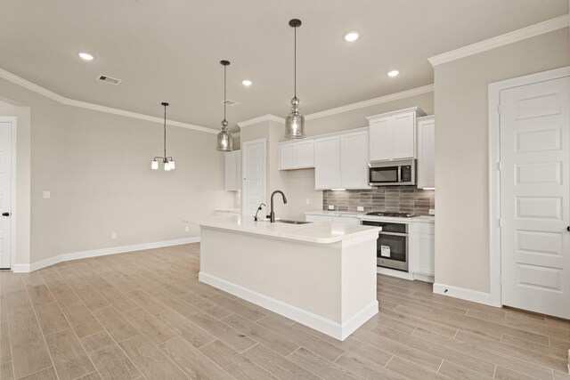 5617 Iris Harvest Dr, Houston, TX 77091 - kitchen with appliances with stainless steel finishes, tasteful backsplash, white cabinetry, light countertops, and ornamental molding