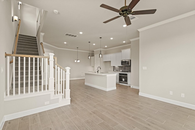 5617 Iris Harvest Dr, Houston, TX 77091 - unfurnished living room featuring crown molding, a ceiling fan, recessed lighting, light wood-type flooring, and stairs