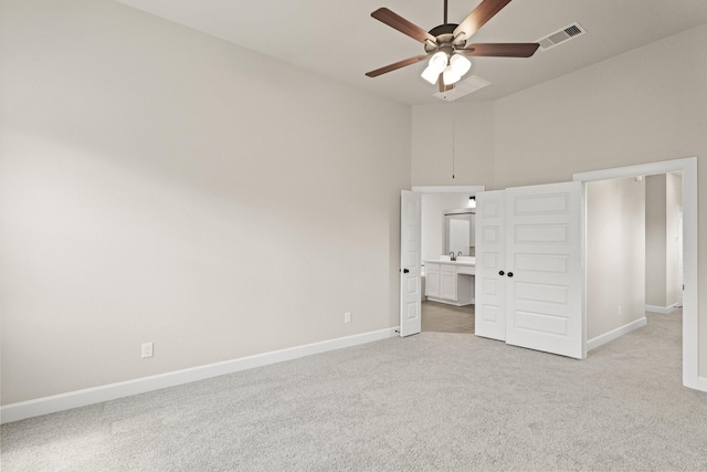 5617 Iris Harvest Dr, Houston, TX 77091 - unfurnished bedroom with light carpet, a high ceiling, connected bathroom, and a ceiling fan
