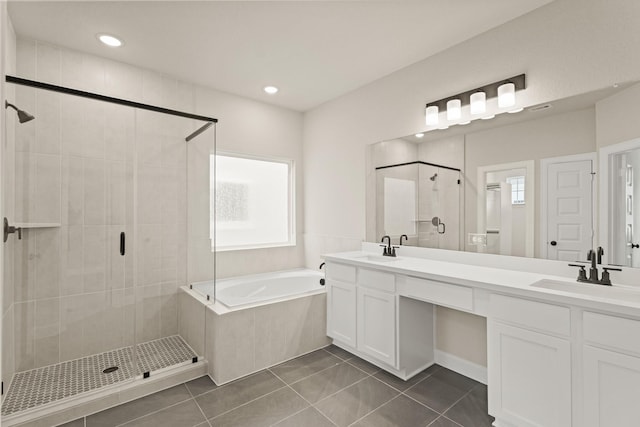 5617 Iris Harvest Dr, Houston, TX 77091 - full bathroom featuring a shower stall, a garden tub, double vanity, tile patterned flooring, and healthy amount of natural light