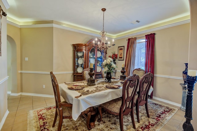 dining room featuring visible vents, baseboards, an inviting chandelier, arched walkways, and tile patterned floors