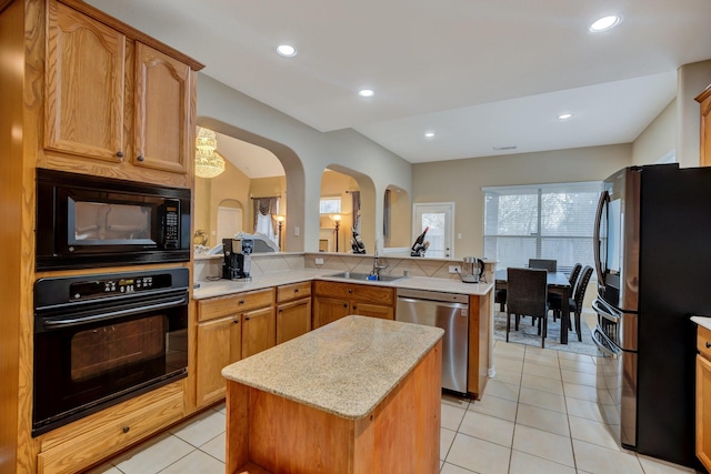 kitchen featuring a sink, black appliances, recessed lighting, and light tile patterned floors