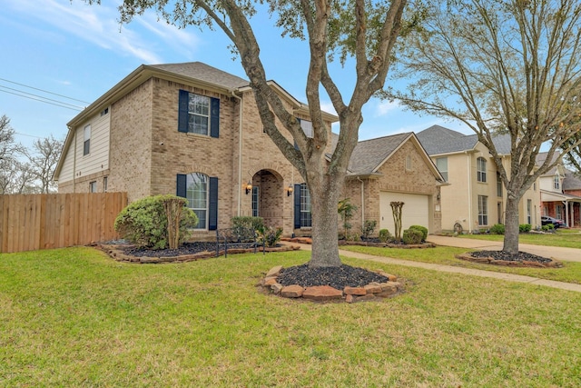 traditional-style house featuring driveway, brick siding, a front yard, and fence