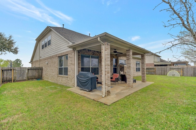 rear view of property with brick siding, a lawn, a patio, a fenced backyard, and a ceiling fan