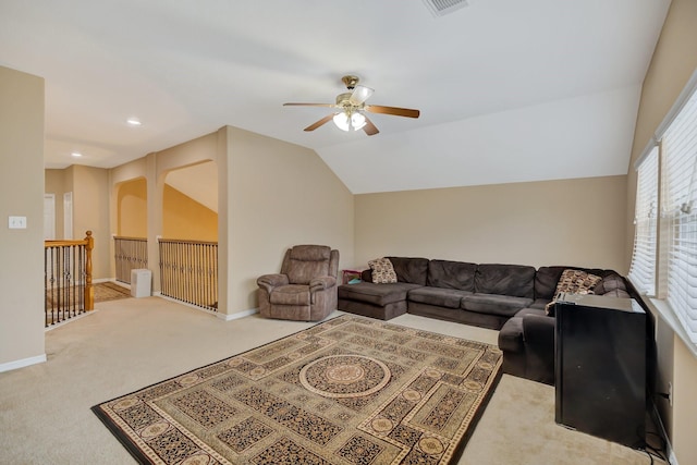 carpeted living area featuring visible vents, baseboards, ceiling fan, and vaulted ceiling